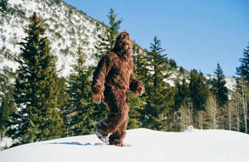 Bigfoot walking in the snow on a mountain